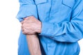 Male hand holding elbow, elderly man suffering from aching bones.  White Royalty Free Stock Photo