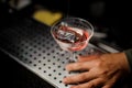 Male hand holding an elegant cocktail glass with sweet alcoholic drink Royalty Free Stock Photo