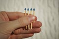 Male hand holding four safety match sticks hidden in the palm with one match stick shorter than the others Royalty Free Stock Photo