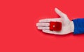 Male hand holding a gift box with engagement ring on red background. Close-up. Top view. Place for text Royalty Free Stock Photo