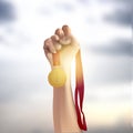 Vector male hand holding gold medal against the sky Royalty Free Stock Photo