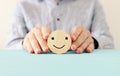 Male hand holding happy face. concept of happiness emotion and satisfaction Royalty Free Stock Photo