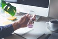 Male hand holding hourglass with worktable.Time,motivation Royalty Free Stock Photo