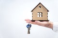 Male hand holding a house model and keys isolated Royalty Free Stock Photo