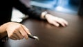 Male hand holding laser pointer in meeting room