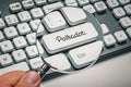 Male hand holding magnifying glass and focusing computer key with polkadot symbol