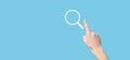 Male hand holding magnifying glass ,search icon on blue background. Concept search engine optimization, customer support.Browsing Royalty Free Stock Photo