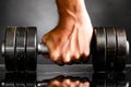 Male hand is holding metal barbell