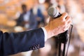 Male hand holding microphone at conference hall Royalty Free Stock Photo