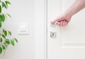 Male hand holding modern door handle. Close-up elements of the interior of the apartmen Royalty Free Stock Photo
