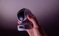Male hand holding modern tiny 8k UHD surveillance camera with the cyclops like