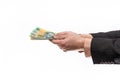 Male hand holding and offering austraian dollar banknotes