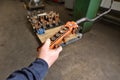 Male hand holding an old and very dirty remote control panel with buttons for an electric winch at the factory Royalty Free Stock Photo