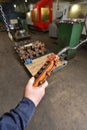 Male hand holding an old and very dirty remote control panel with buttons for an electric winch at the factory Royalty Free Stock Photo