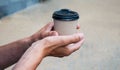 male hand holding a paper cup of coffee Royalty Free Stock Photo