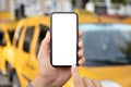 male hand holding phone with isolated screen yellow taxi cars Royalty Free Stock Photo