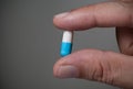 Male hand holding pill. Royalty Free Stock Photo