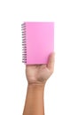 Male hand holding a pink book isolated on white background Royalty Free Stock Photo