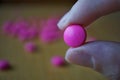 Male hand holding a pink pill as a symbol of pharmacy Royalty Free Stock Photo