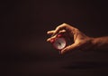 Male Hand Holding a Red Clock