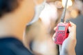 The male hand holding with a red Walkie Talkie or Portable radio transceiver for communication Royalty Free Stock Photo