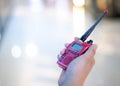 The male hand holding with a red Walkie Talkie or Portable radio transceiver for communication Royalty Free Stock Photo