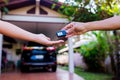 Male hand holding a remote car key and handing it over to give a Royalty Free Stock Photo