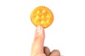Male hand holding round cracker cookie isolated on white background Royalty Free Stock Photo