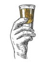 Male hand holding a shot of alcohol drink
