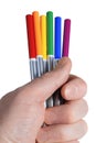 Male hand holding six colored pencils in LGBT rainbow colors. Bright color pencils isolated on white background. Closeup Royalty Free Stock Photo