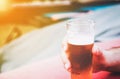 Male hand holding a small glass of cold beer Royalty Free Stock Photo