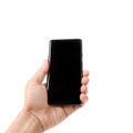 Male hand holding a smartphone with black screen isolated on white