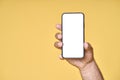 Male hand holding smartphone with white screen isolated on yellow background. Royalty Free Stock Photo