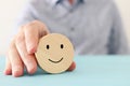 Male hand holding smiley face. concept of happiness emotion and satisfaction Royalty Free Stock Photo