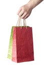 Male hand holding two shopping bags isolated on white Royalty Free Stock Photo