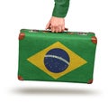 Male hand holding vintage Brazilian flag suitcase Royalty Free Stock Photo