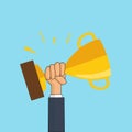 Male hand holding winner`s Gold Trophy Cup. Winner trophy awards. Trophy cup flat icon. Success and business goals concept. Royalty Free Stock Photo