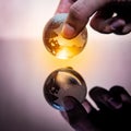 Male hand holding world globe crystal glass Royalty Free Stock Photo