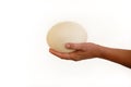 Male hand holds of big ostrich egg on white background, size comparison, close up. Organic fresh egg. Healthy food. Ostrich egg. Royalty Free Stock Photo