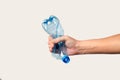 male hand holds and crushes a plastic bottle Royalty Free Stock Photo