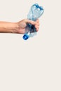 male hand holds and crushes a plastic bottle Royalty Free Stock Photo