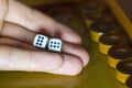 Male hand holds dice in the game of backgammon Royalty Free Stock Photo