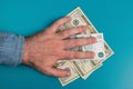 Male hand holds dollar bills studio image. Money in the male hand