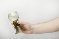 Male hand holds a medieval wine glass