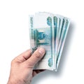 Male hand holds several banknotes worth one thousand rubles on white