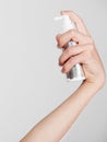 Male hand holds spray cosmetic for hair