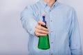 Male hand holds spray gun. Green spray bottle. Front view