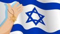 Male hand holds Star of David keychain against background of flag of Israel. Judaism. Celebration Hanukkah, Festival of Lights.