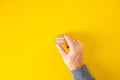 Male hand holds a wooden block with the word apply now on yellow background