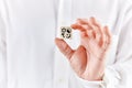 Male hand holds a wooden cube with four religious icons of Judaism, Islam, Christianity and Taoism